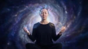 A woman meditates with closed eyes, hands raised, surrounded by ethereal blue, lavender, and gold energy against a cosmic nebula.